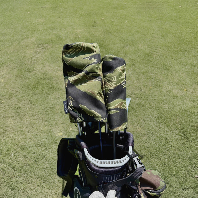 The Long Grass jungle tiger stripe camo headcovers on driver and wood in golf bag on course