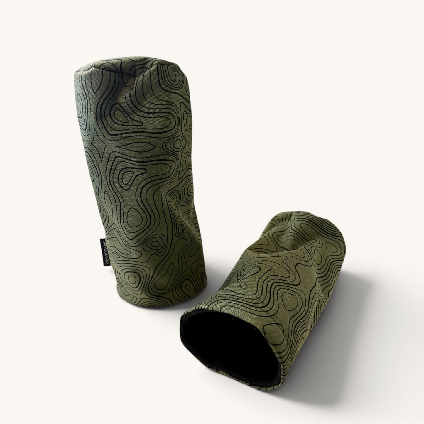 Greyside Golf green topographic Camo driver headcover made from Cordura, with black fleece interior and elastic closure.