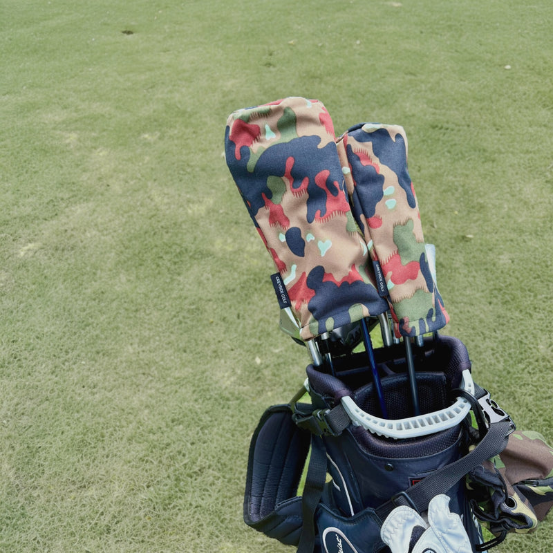 The High Ground Swiss Alpenflage camo headcovers on driver and wood in golf bag on course