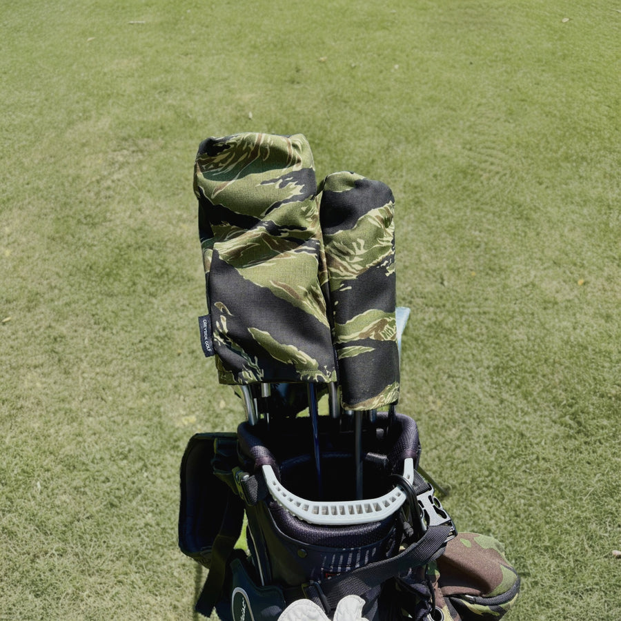 The Long Grass jungle tiger stripe camo headcovers on driver and wood in golf bag on course