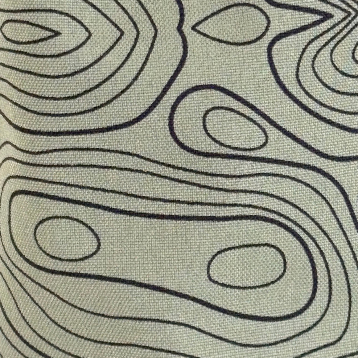 Close-up of green topographic fabric on The Azimuth golf headcover