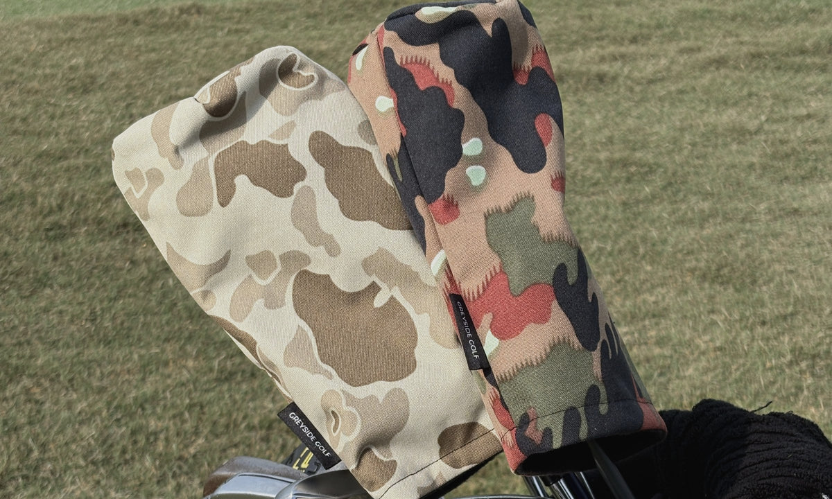 The Beach Side desert frogskin and The High Ground Swiss Alpenflage camo golf headcovers on clubs in a golf bag on the course