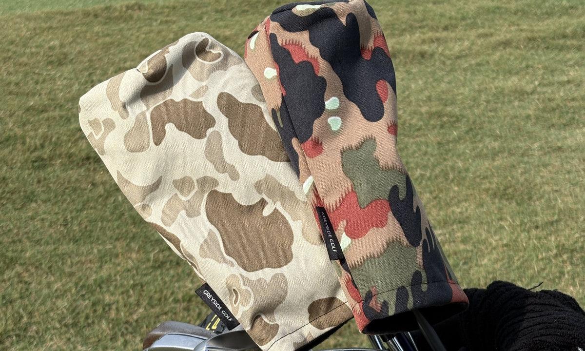The Beach Side desert frogskin and The KSK Swiss Alpenflage headcovers on clubs in a golf bag on the course